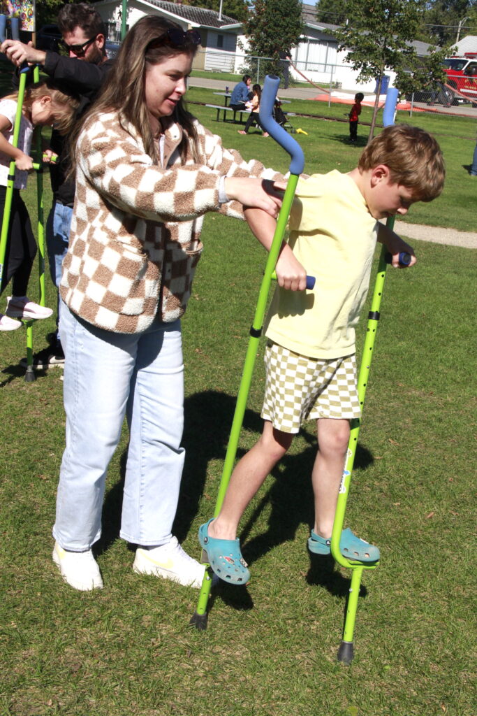 Gabby Ruseff helps Gray on stilts 2